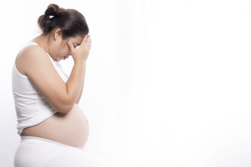 young pregnant woman suffering with a headache