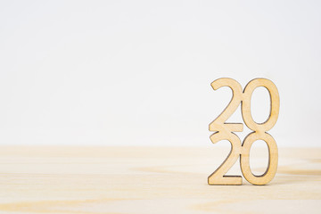 wooden word " 2020 " on table and white background