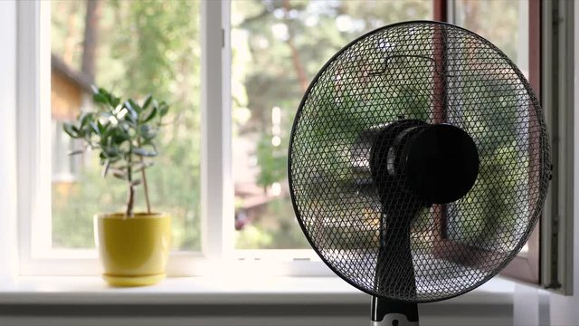 electric fan working in a room on hot summer day