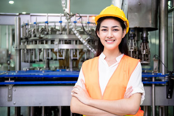 Young engineer inspecting production line.