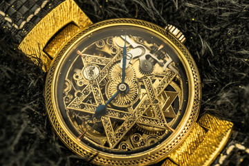 Fototapeta na wymiar Vintage skeleton watch with Star of David on black fur background