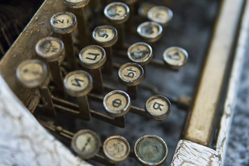 Close up view on an old dirty broken antique typewriter machine keys with Cyrillic symbols letters.