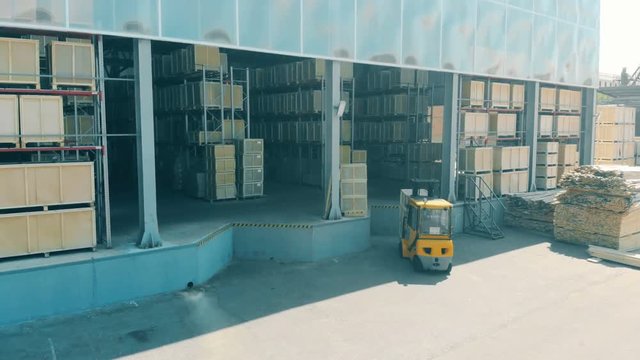 A fork lifter works with boxes.