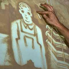 Artist paints sand