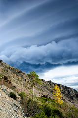 Sunny day at the mountains with colorfull clouds