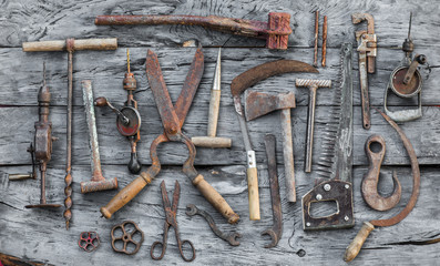 old vintage rusty hand tool on a wooden table