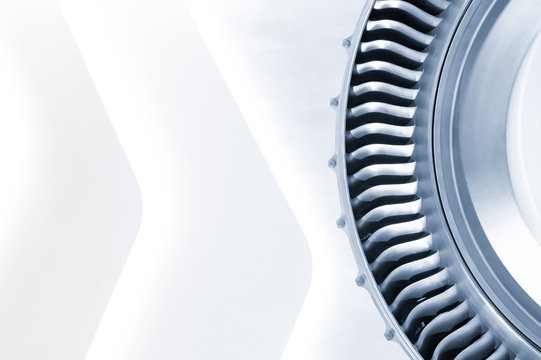 blue toned jet engine close-up with a light copy-space background