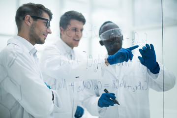 group of scientists discusses the information and makes notes