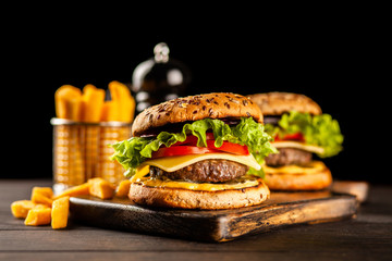 Delicious grilled burgers © George Dolgikh