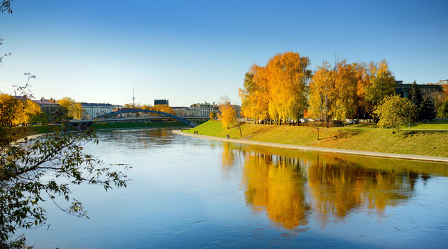 Colorful city park scene in the fall with orange and yellow foliage. Autumn scenery in Vilnius, Lithuania.