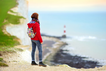 Young female tourist enjoying beautiful view of white chalk cliffs of the Seven Sisters at Birling...