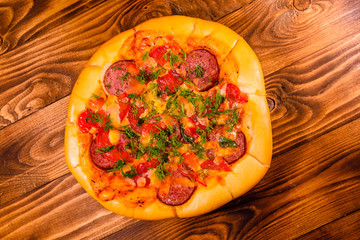 Fresh homemade pizza on a wooden table. Top view