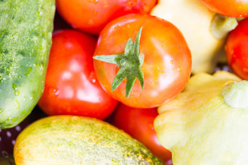 Tomato, cucumber, zucchini, patisson in an iron pan on a wooden table. Concept of a healthy diet, dietetic vegetables. Harvesting