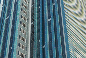 Obraz premium texture of a skyscraper, walls of a high-rise building with windows