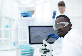 young scientist on the blurred background of modern laboratory