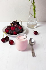 Cherry yogurt in glass, with fresh cherries