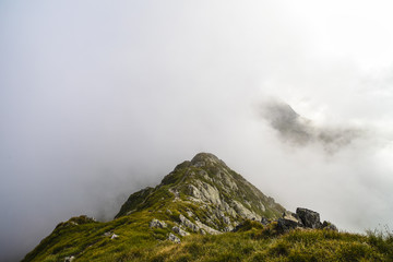 Summer landscape with high mountains and clouds in a summer day
