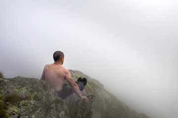 Active man doing exercises in a gorgeous mountain view