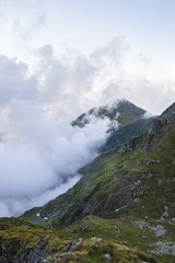 Summer landscape with high mountains and clouds in a summer day