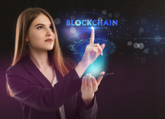 The concept of business, technology, the Internet and the network. A young entrepreneur working on a virtual screen of the future and sees the inscription: blockchain