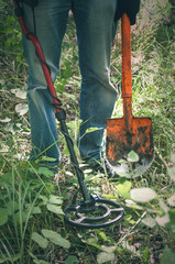 Metal detector and coin finder. Treasure hunting concept. In searching of ancient relics.