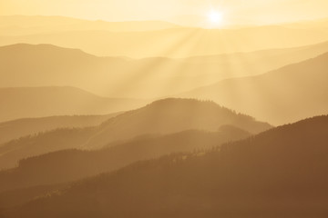 Mountains covered with woods in the early morning mist