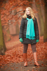 Girl is walking through the park.