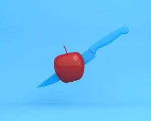 Obraz premium Creative layout made of knife blue in apple on blue background. minimal idea food concept. An idea creative to produce work within an advertising marketing communications or artwork design.