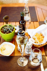 Wine and water at the table. Outdoor Italian restaurant terrace. Concept of summer authentic meal