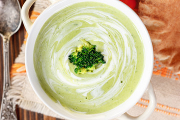 Beautiful vegetarian broccoli soup in a white bowl.