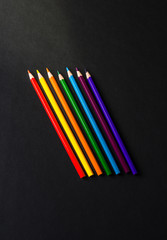 Colour pencils isolated on black background