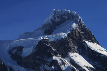 Snowy mountain summit with blue sky