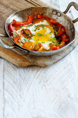 Fried egg with a bell pepper and tomatoes