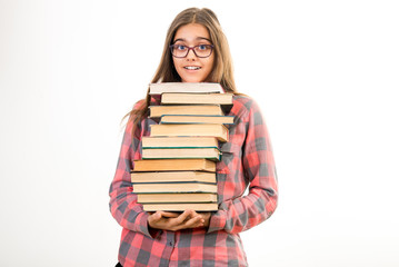 Girl with many books. A student holds a large stack of books. Ubcheba at school. Library. Beginning of studies at the Institute. Young girl with a book in glasses
