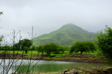 Obraz premium lush green landscape of mountain and hills in monsoon season, Purandar, Maharashtra, India