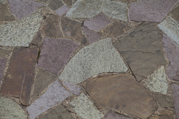 Rough multycolored unregular shape Stones floor with white cement between