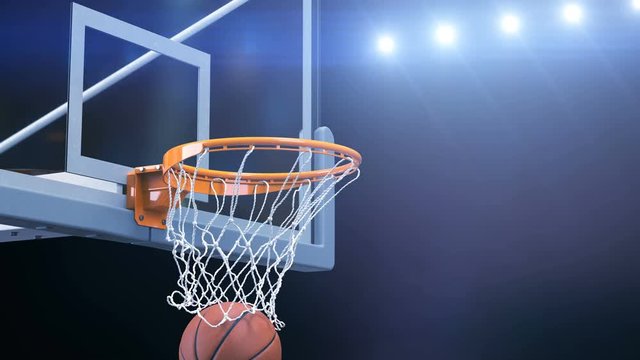 Beautiful Basketball Ball Hits Basket Net Slow Motion Close-up Camera Fly. Ball Flies Spinning into Basketball Hoop with Blue Stadium Lights. Sport Concept 3d Animation 4k Ultra HD 3840x2160.