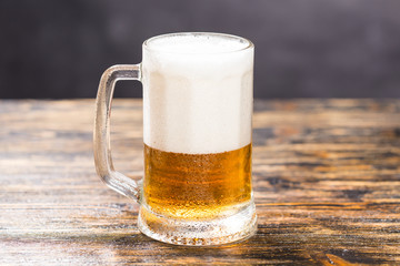 Alcohol, liquid, food concept- a mug of beer on a wooden table
