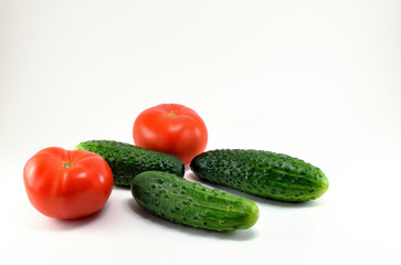 Ripe red tomatoes and cucumbers from the garden.