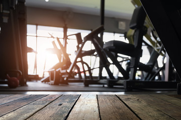 Empty desk space platform and fitness gym background with weight stack. For product display montage.