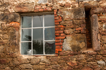 Stone wall with black window