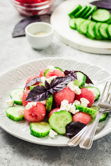 Watermelon cucumber feta salad with balsamic dressing. Selective focus, copy space.