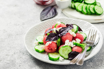 Watermelon cucumber feta salad with balsamic dressing. Selective focus, copy space.