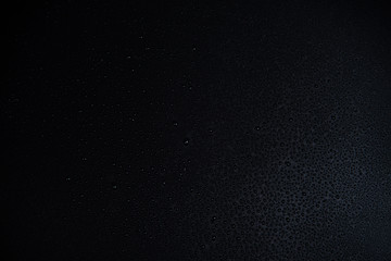 Drops of water on black background.
