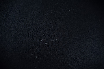 Drops of water on black background.