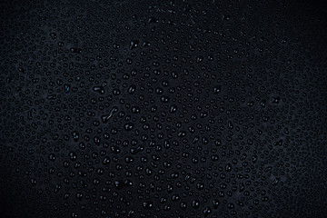 Drops of water on black background.