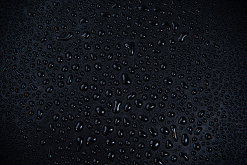 Drops of water on black background.