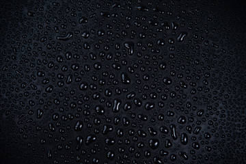 Drops of water on black background.