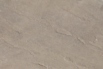 Smooth flat pink stone wall surface with small defects