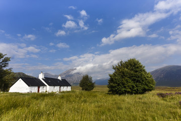 Scenic view of Glencoe with cute little white houses in the scottish Highlands, Scotland